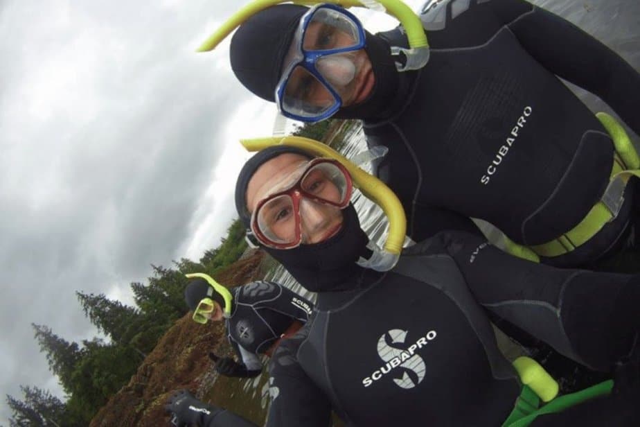 two people wearing wet suits while snorkeling in Alaska