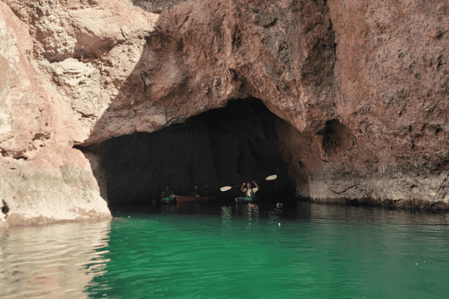 opening of emerald cave with 3 kayaks inside