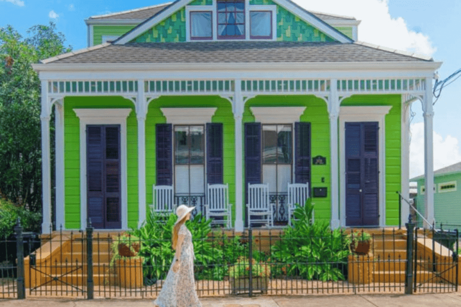 girl walking in front of green house in New Orleans, LA for mother's day getaway