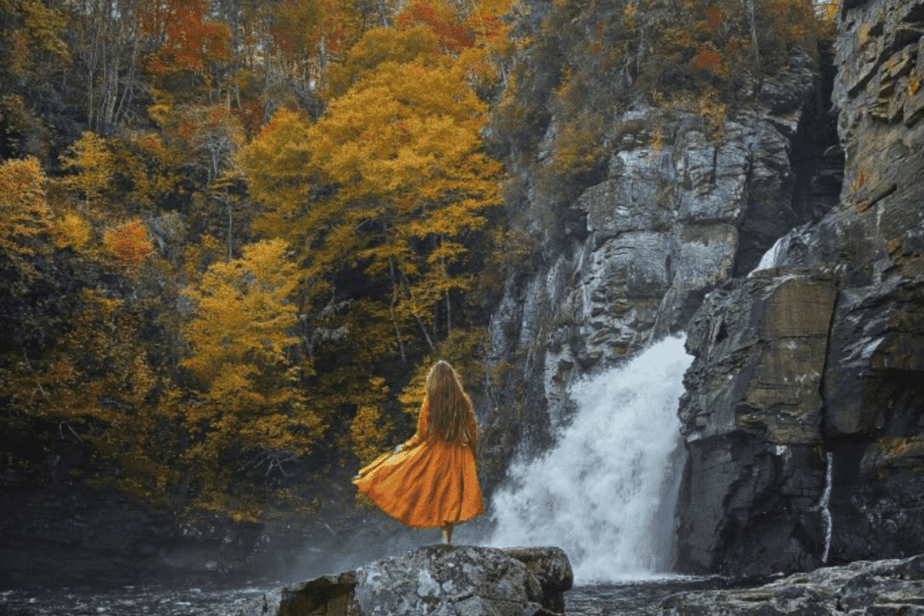girl with dress standing in front of Linville Falls- best waterfalls in the usa