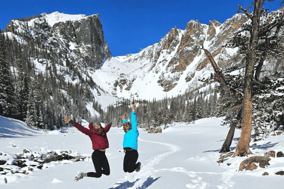 two people jumping on hike at Rocky Mountain National Park