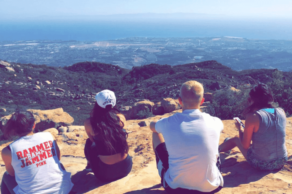 4 people sitting at the top of inspiration point day hike near los angeles 