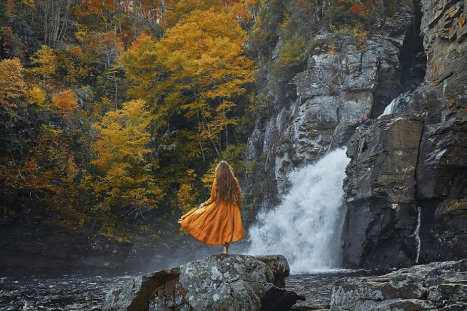 girl on rock in front of waterfall during a seculded honeymoon in Asheville 