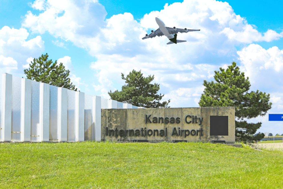 kansas city international airport sign with plane flying overhead 