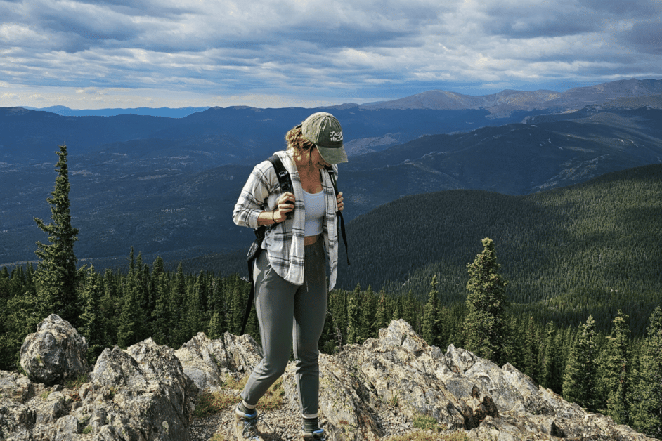 Girl at top of mountain wearing hiking boots. 