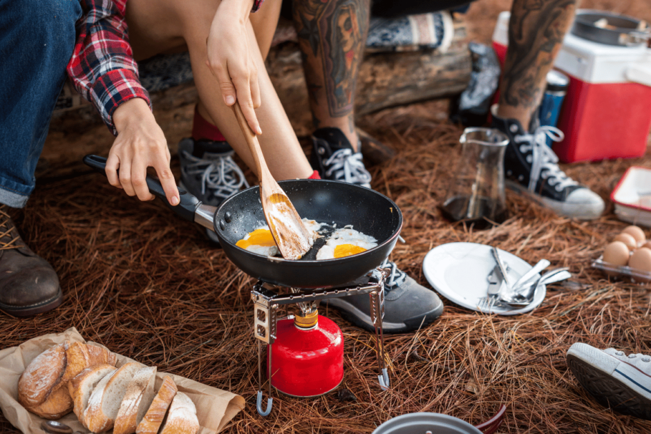 couple cooking while camping