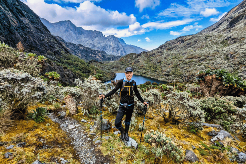 Women's best outdoor travel clothing brands. Woman with trekking poles on a hike. 