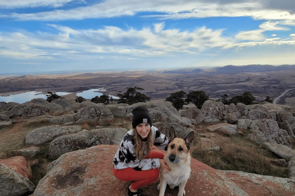 Girl and german shepherd dog during a oklahoma weekend getaway to the Wichita mountains. 