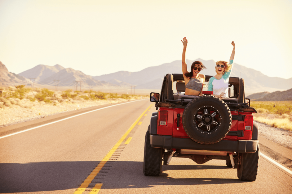 two girls in a jeep with trivia questions for a usa road trip. 
