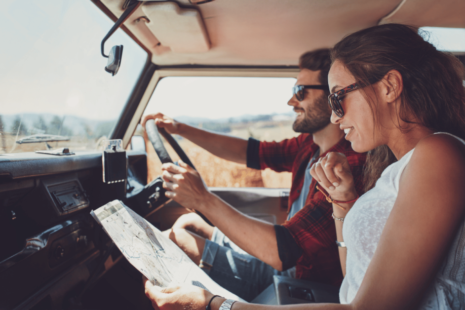 couple looking at a map on a usa road trip.