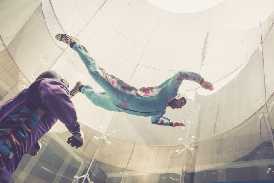 Two people indoor skydiving. 