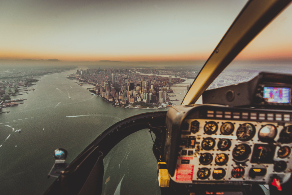 helicopter ride over city skyline at sunset. 