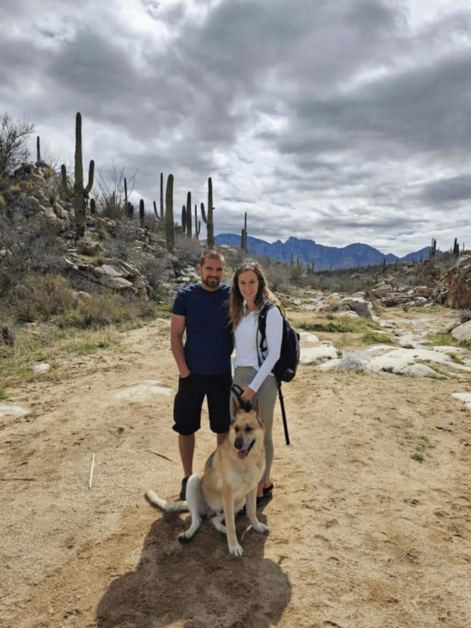 Two people and a dog hiking in Tucson. 