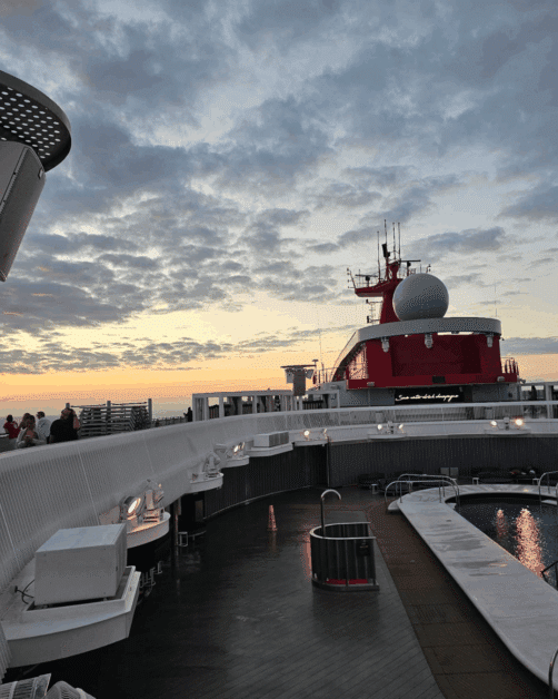 sunset on virgin voyage cruise pool deck.
