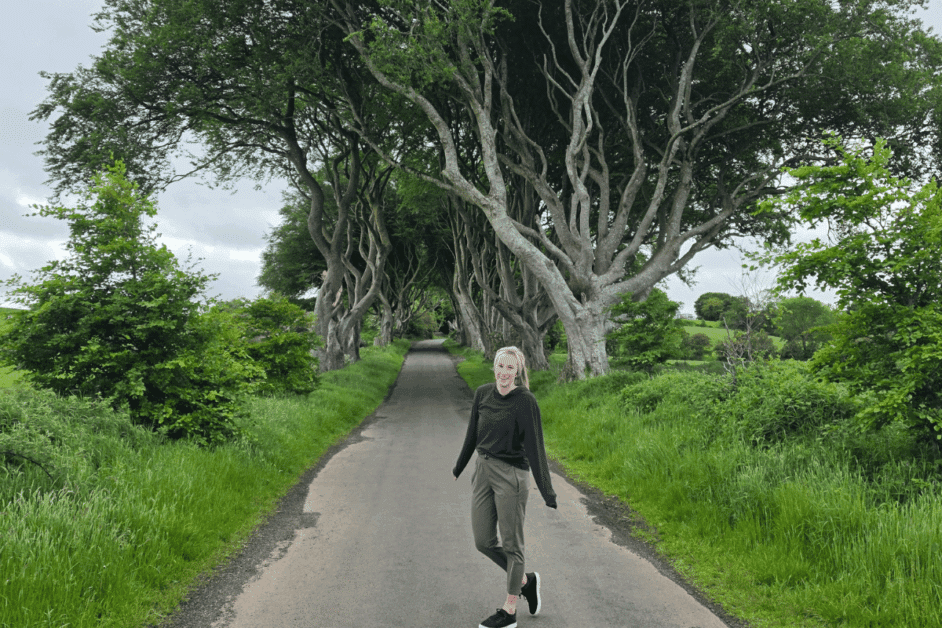 girl at the dark hedges in northern ireland. a filming spot in Game of Thrones. 