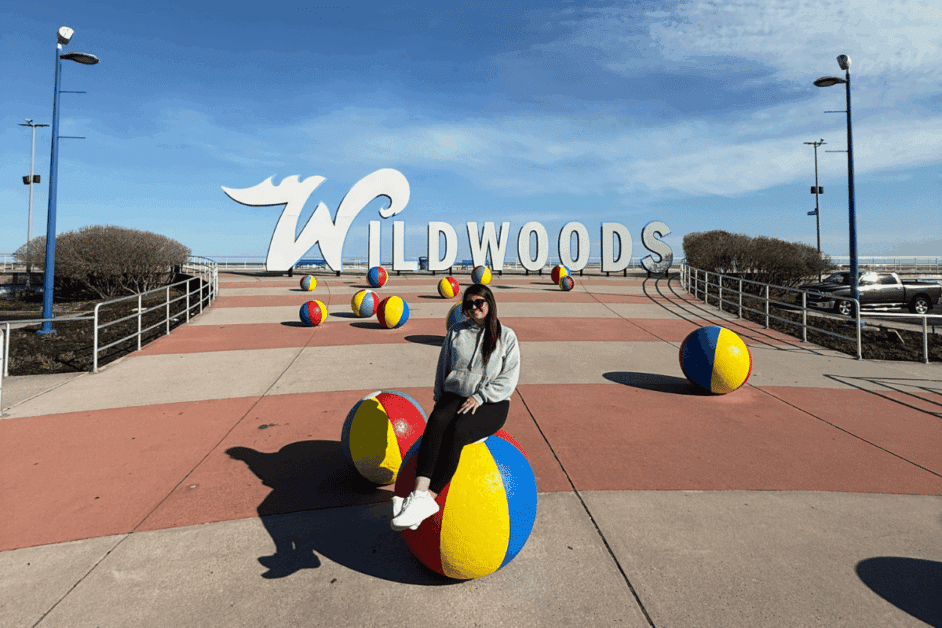 girl in front of wildwoods sign. 