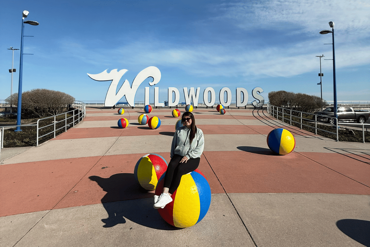 girl in front of wildwoods sign.