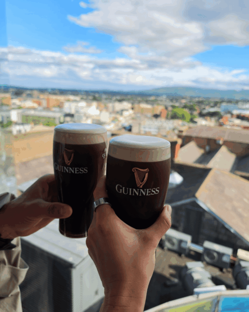 two guinesses with dublin's skyline.